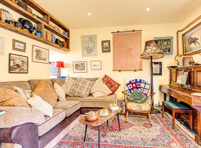 A living room with a sofa, table, and lamp at Family Country Cottage with a private Valley View