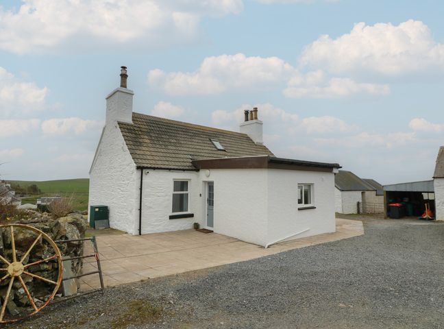 A cottage with a white exterior and patio at South Kirklauchline Farm Stoneykirk near Sandhead