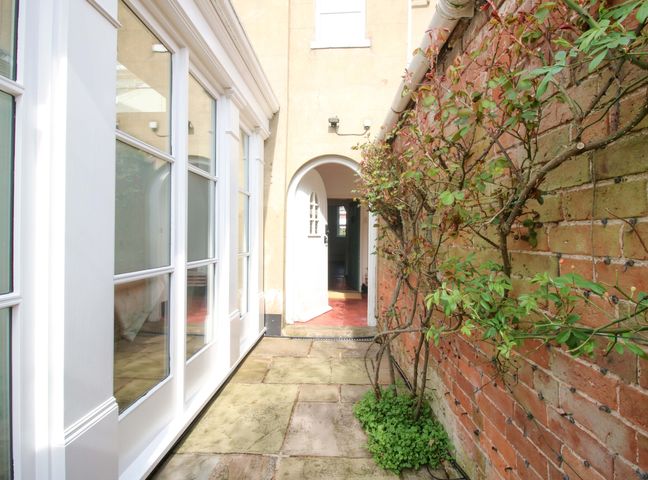 An outdoor area with a pathway and plants at The Apartment at the Grey House in Albrighton