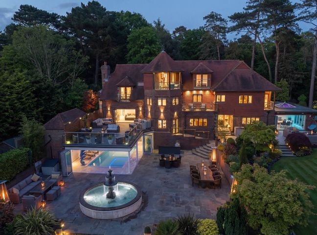 A house with a swimming pool and outdoor seating at Hamble House in Warsash