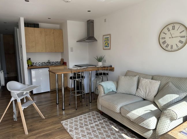 A living room with a dining table and sofa at Dog-friendly lodge, steps to St Ives train, Hayle