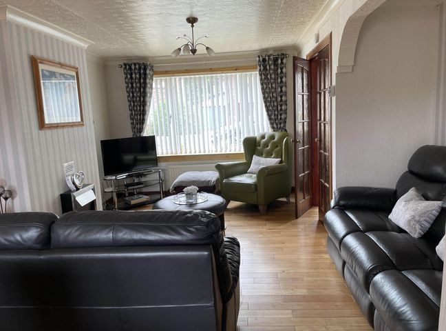 A living room with a television and seating area at Spacious family base with garden near Loch Ness
