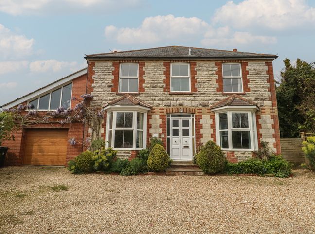 A house with garage and pathway at Millmead House in Portesham