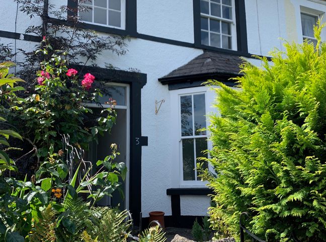 An outdoor view of a house with plants and flowers at 3 Newboro Terrace in Conwy