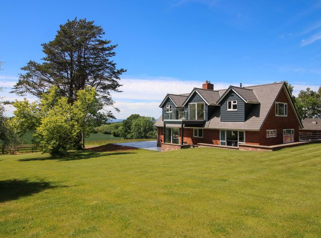 A house with a lawn and trees at Westington Hall Hatfield near Bromyard