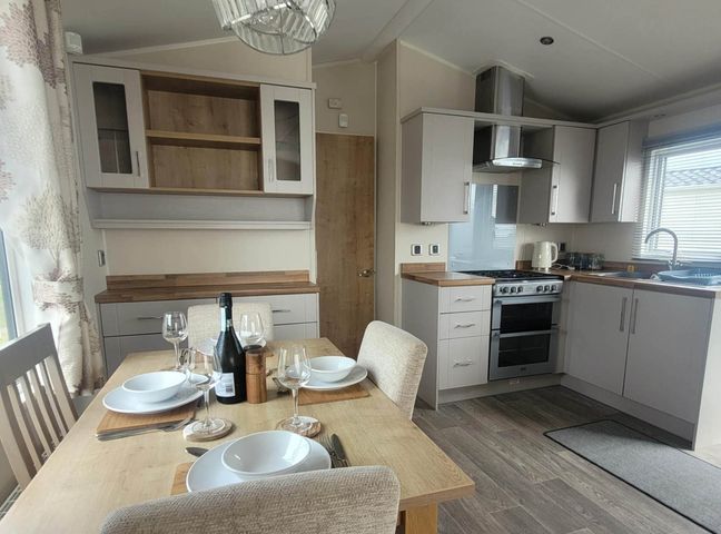 A kitchen with a dining table set at Beachside Lodge - Sleeps 6 - Pets ok - Parking, Heysham