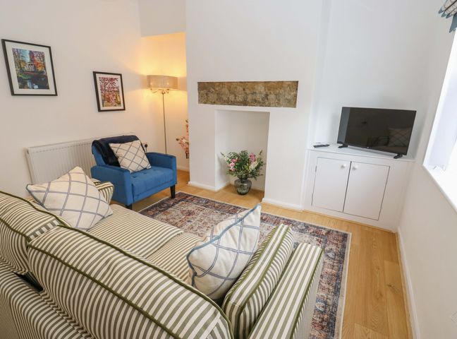 A living room with a sofa and armchair at Saltaire House in Saltaire
