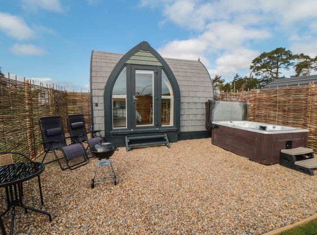 An outdoor area with a hot tub and seating at Cosy Cocoon in Malton