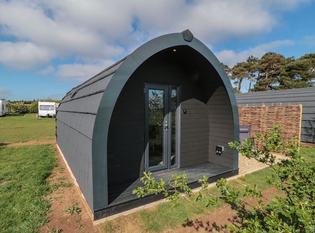 A cabin exterior with a door and windows at Natures Nest in Malton