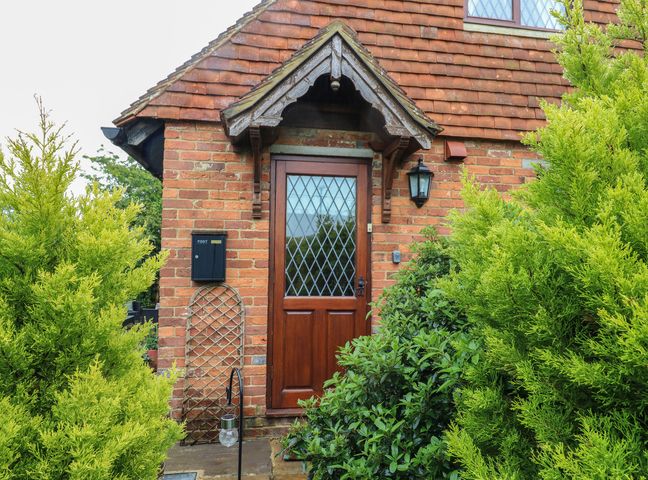 A front entrance with a door and mailbox at Barclay Cottage in Biddenden