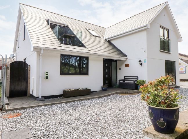 A house exterior with a front door and garden at Seagull Shack Morfa Bychan