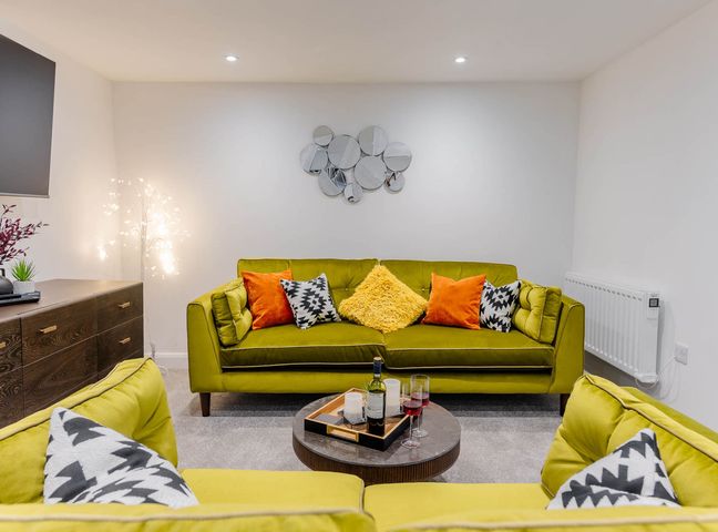A living room with a sofa and coffee table at Cosy 2-Bed Apartment in Nettleham