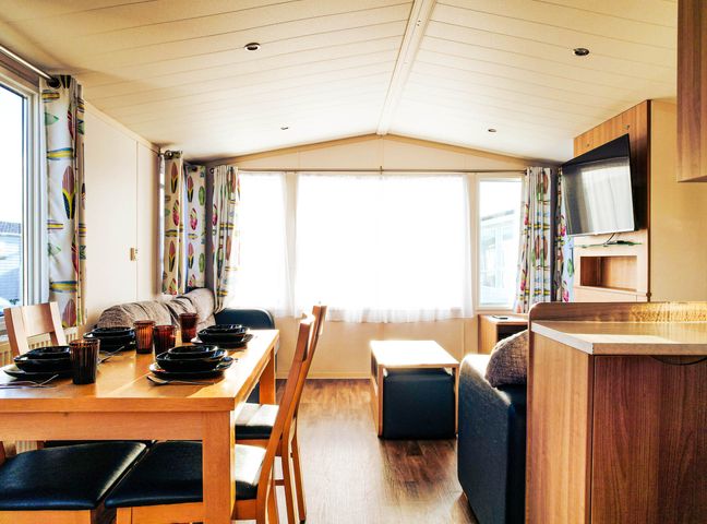 A living room with a dining table and chairs at Captivating 6-Person Caravan in Rhyl