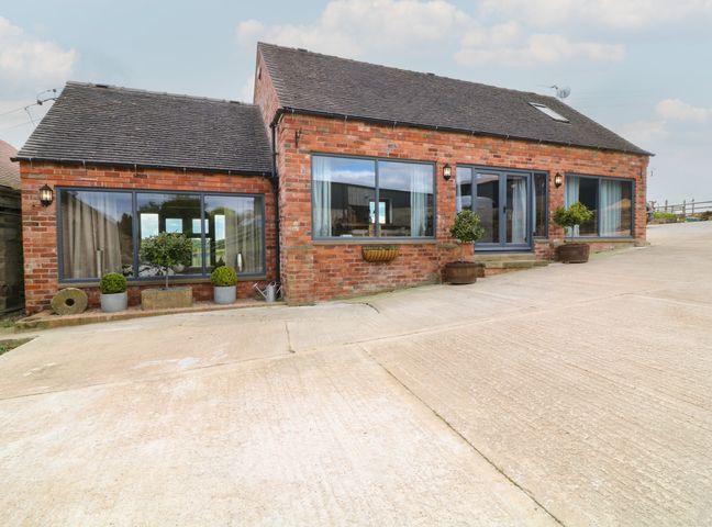 A house with windows and planters at The Croft, Home Farm in Ripley