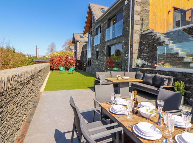 An outdoor dining area with a table and chairs at Midways in Windermere