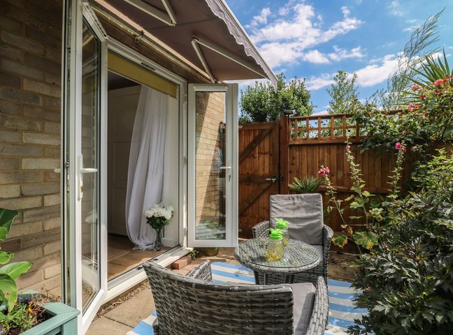 A garden with seating and plants at Oakwood Annexe in Colchester