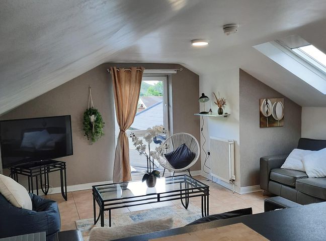 A living room with a television and a coffee table at the property