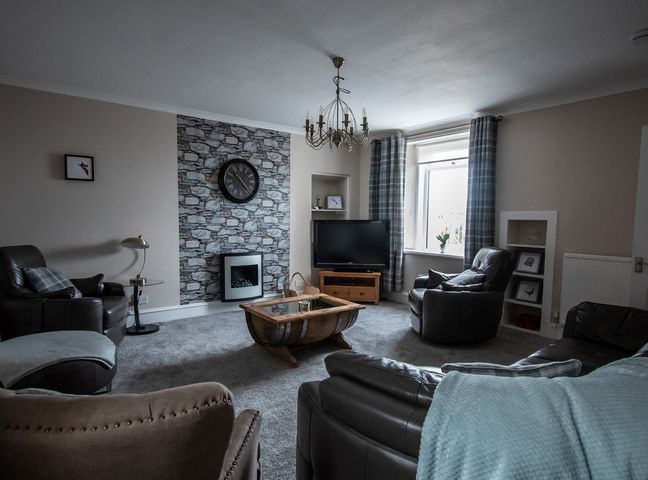 A living room with a coffee table and sofa at the property in the location