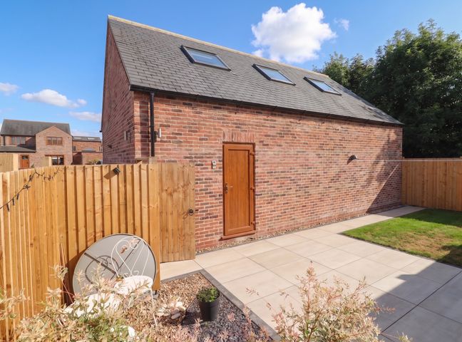An outdoor view of a house with a patio and fence at Fields view in Bridlington