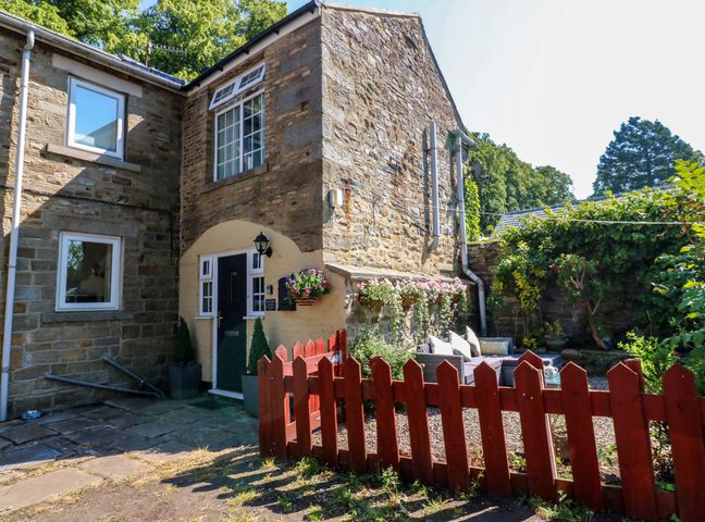 An outdoor view of a house with a garden at Arch Mews Cottage Middleton-In-Teesdale