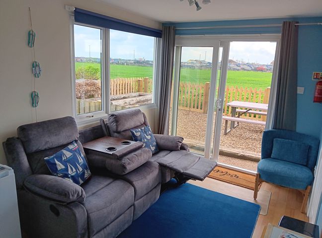 A living room with a sofa and armchair at Bay View Chalet 2 Bed Sleeps 4 Pets Garden Beach Wilsthorpe near Bridlington