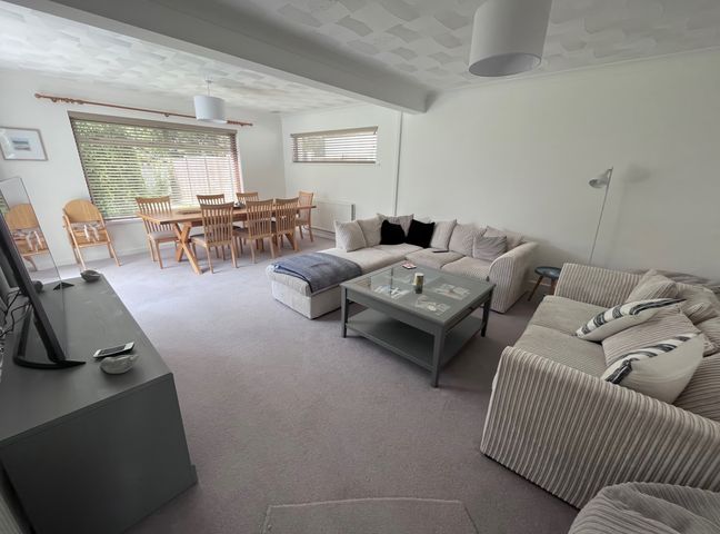 A living room with a dining table and chairs at Sleeps 9 KingBeds Family Friendly, Pityme near Penmayne