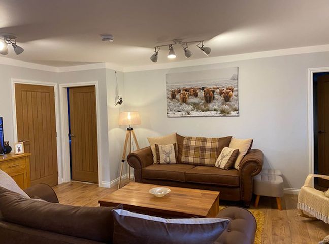 A living room featuring a sofa, coffee table, and wall art at Blairgowrie Luxury 3 Bed Lodge with Hot Tub in Blairgowrie