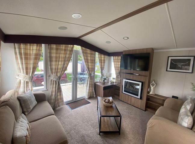 A living room with a sofa and television at The Old Barn in Manchester