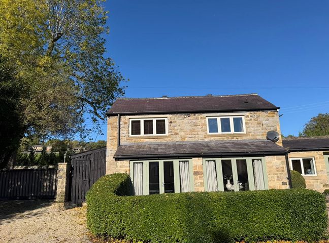 A house with trees and a gate at Honey Pot Cottage near Harrogate
