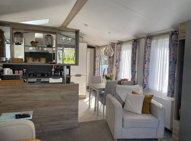 A kitchen and dining area with seating at Findhorn Lodge Peaceful Sleeps 4 in Forres