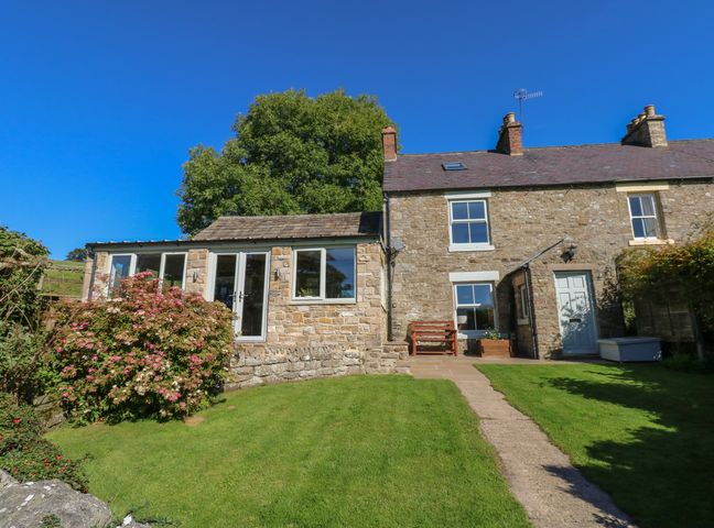 Stone house with extension and garden path leading to front door at Hoodgill Barn in Newbiggin near Middleton-in-Teesdale