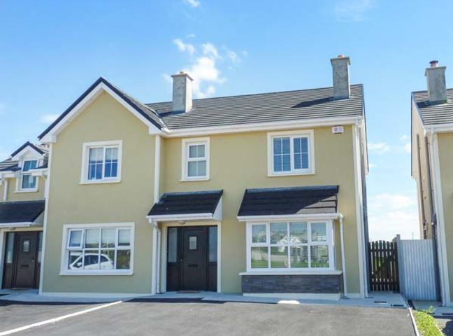 A semi detached house with driveway and windows at 63 Moinin in Kilkee County Clare