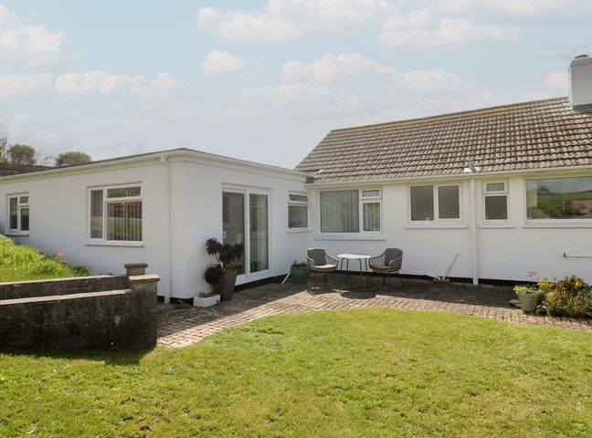 An outdoor area with a table and chairs at Bre An Mor in Praa Sands