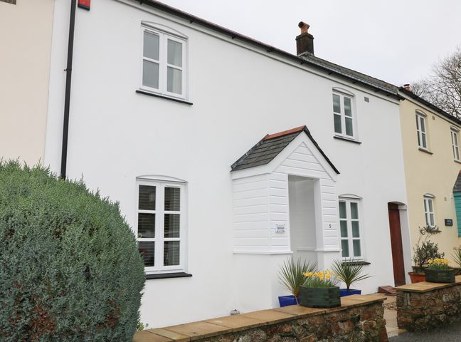 A row of terraced houses with white and cream walls and a small porch at Speedwell in Charlestown