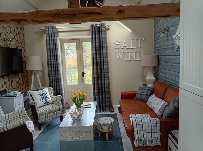 A living room with a sofa and armchairs at Saltwind Granary in Clovelly