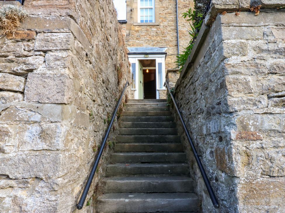 A staircase leading to a doorway at Old Workhouse Cottage Stanhope