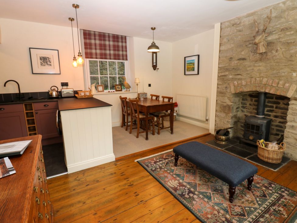 A kitchen and dining area with a table and chairs at Old Workhouse Cottage Stanhope