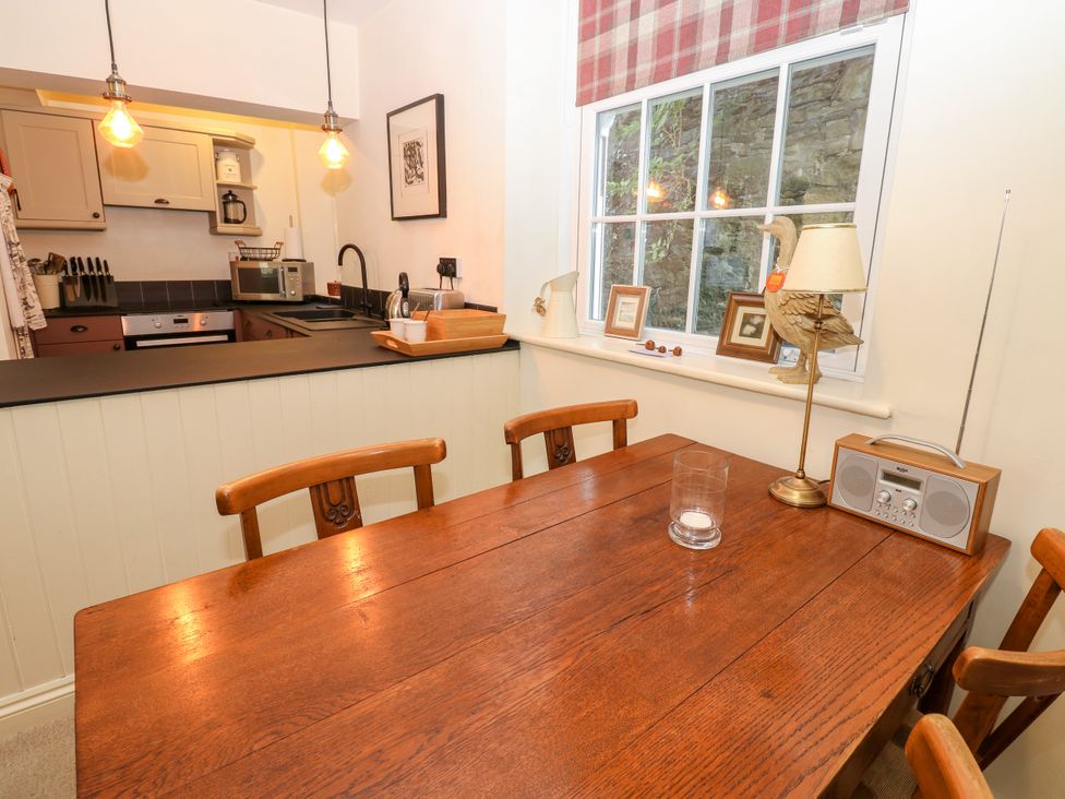 A kitchen with a wooden table and chairs at Old Workhouse Cottage in Stanhope