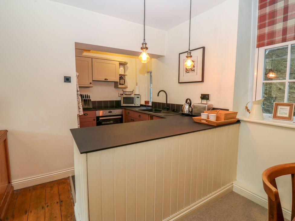 A kitchen with countertop and appliances at Old Workhouse Cottage Stanhope