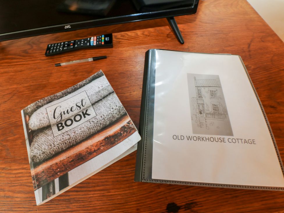 A guest book and information folder on a table at Old Workhouse Cottage Stanhope
