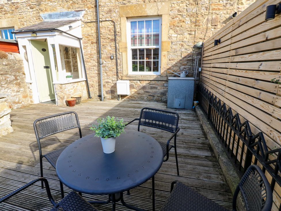 An outdoor space with a table and chairs at Old Workhouse Cottage Stanhope
