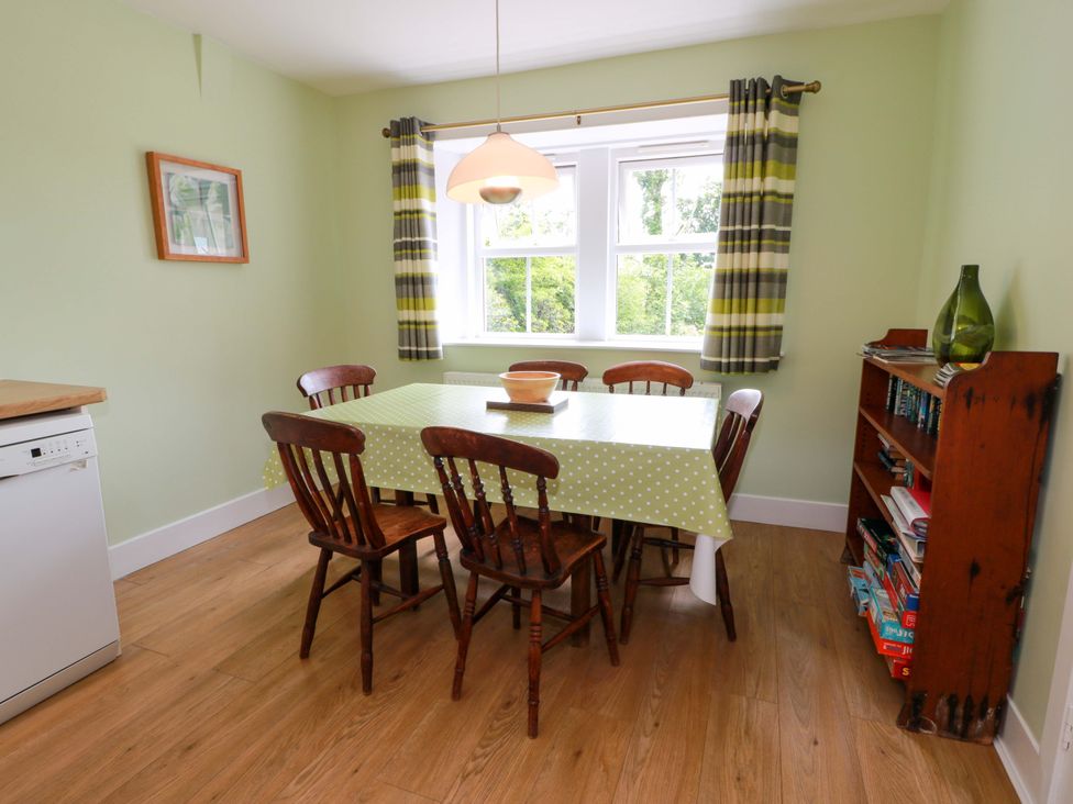 A dining room with a table and chairs at Cairnhill in Girvan