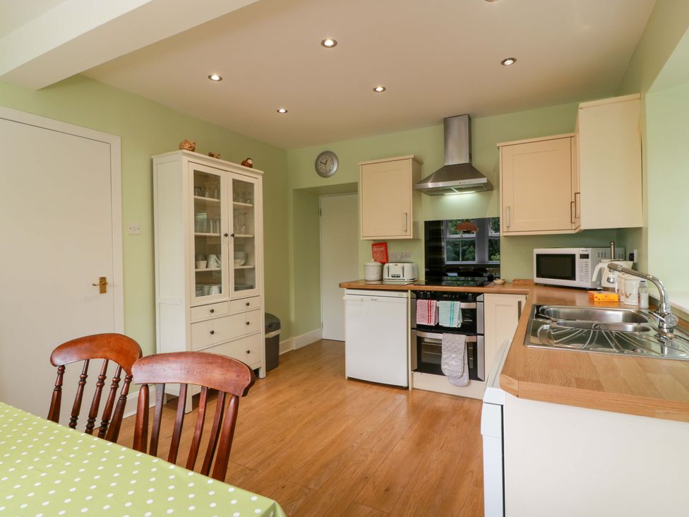 A kitchen with a table and chairs at Cairnhill in Girvan