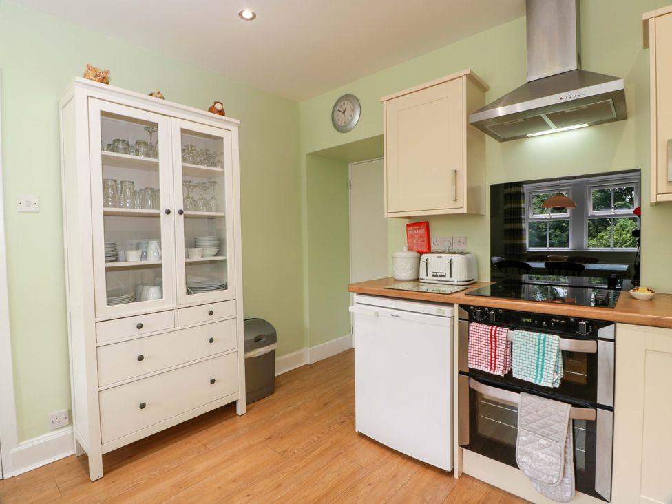 A kitchen with cabinets and an oven at Cairnhill in Girvan