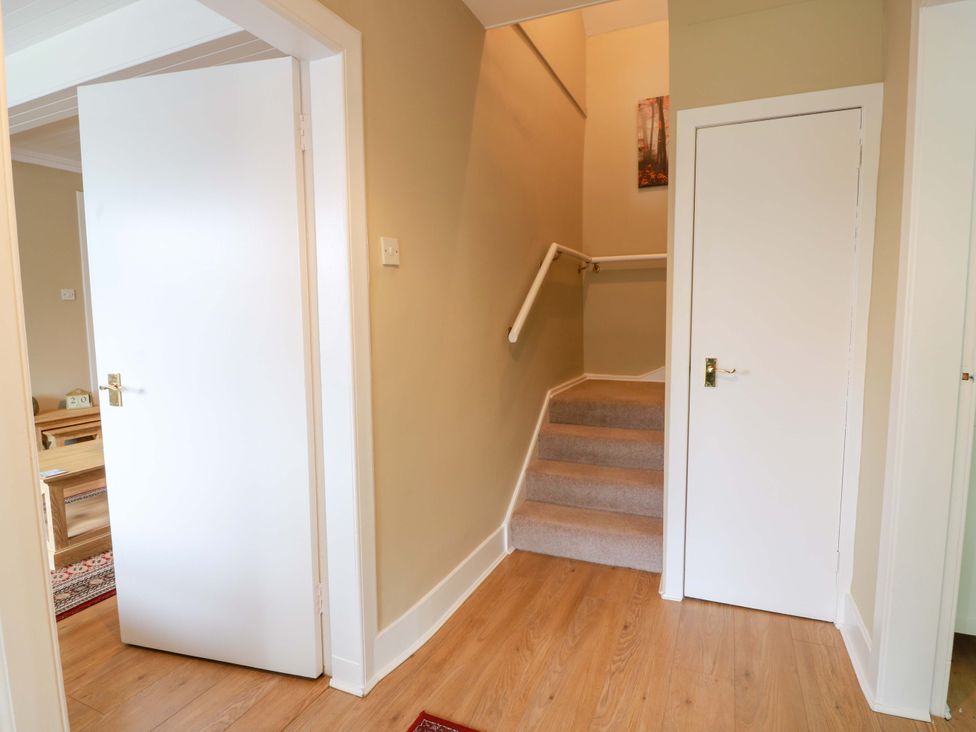 A hallway with a staircase and doors at Cairnhill in Girvan