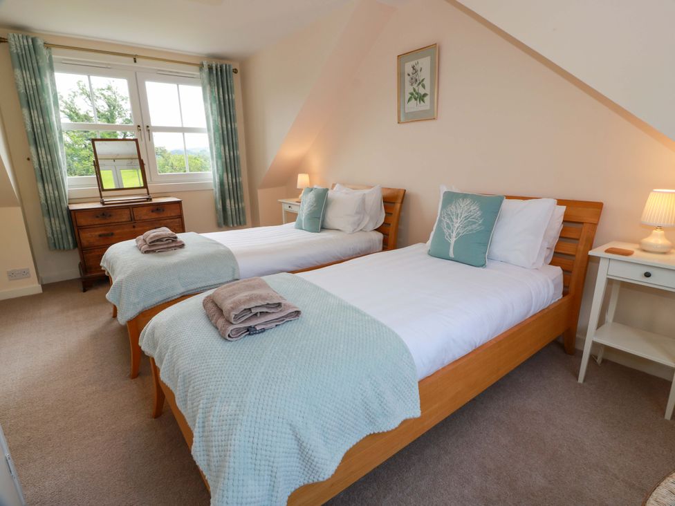 A bedroom with two beds and a chest of drawers at Cairnhill in Girvan