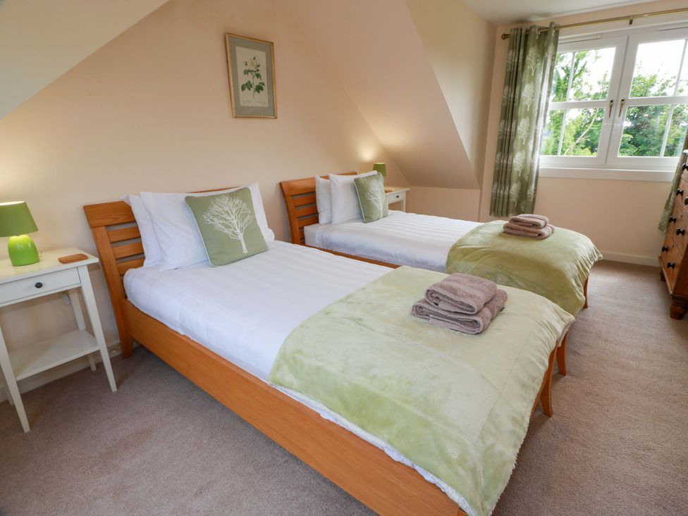 A bedroom with two beds and a nightstand at Cairnhill in Girvan