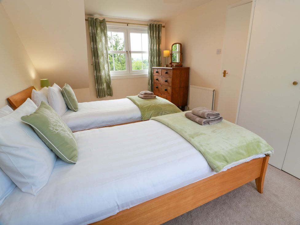 A bedroom with twin beds and a dresser at Cairnhill in Girvan