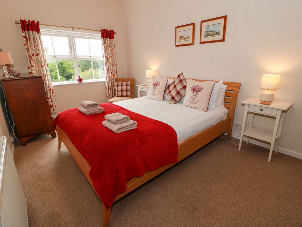 A bedroom with a bed and bedside tables at Cairnhill in Girvan