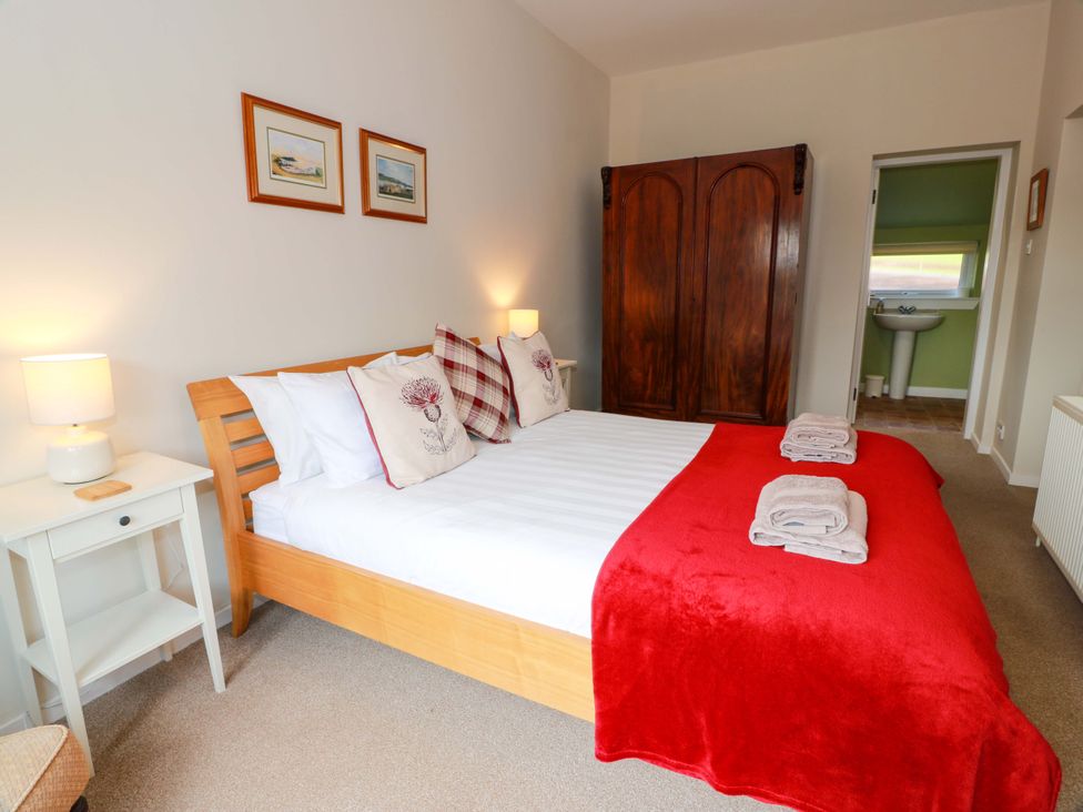 A bedroom with a bed and wardrobe at Cairnhill in Girvan